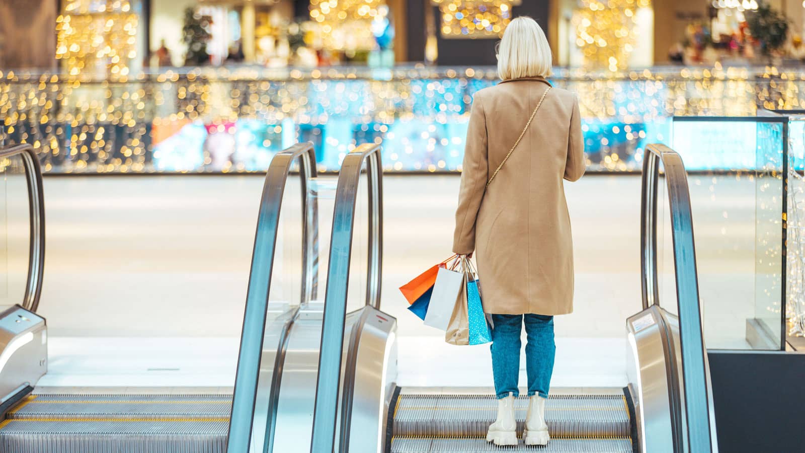 Woman on an escalator while shopping in a shopping centre